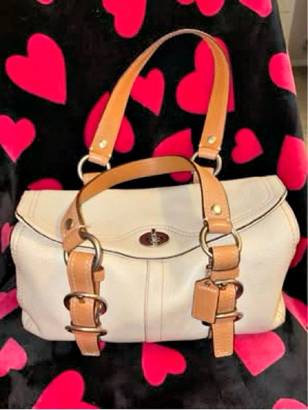Coach Chelsea Turnlock Satchel made from cream-colored pebbled leather with tan